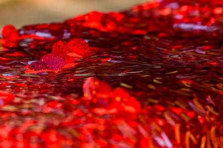 Red sequins pattern. Sparkling sequins background. Red sequin fabric for background. rectangular red shiny fabric with sequins, Christmas background. Sequins on Fabric, red Beads. Fashion Fabricの写真素材