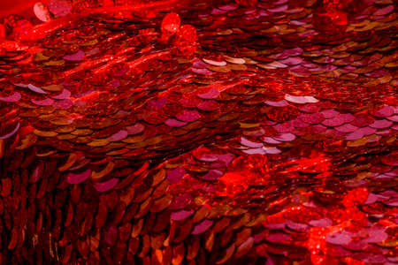 Red sequins pattern. Sparkling sequins background. Red sequin fabric for background. rectangular red shiny fabric with sequins, Christmas background. Sequins on Fabric, red Beads. Fashion Fabricの写真素材
