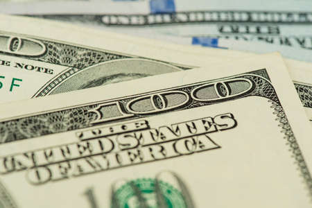 One hundred dollars pile as background. A background from many hundred dollar banknotes