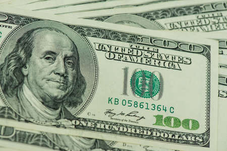 One hundred dollars pile as background. A background from many hundred dollar banknotes