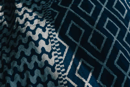 material textile background. Blue fabric in diamonds. Close-up of the white blue diamond shaped...