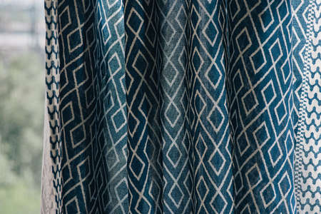 material textile background. Blue fabric in diamonds. Close-up of the white blue diamond shaped...