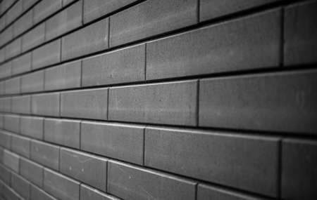 Black brick wall. Urban black brick wall texture masonry background.