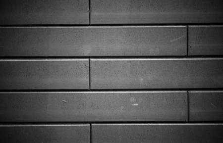 Black brick wall. Urban black brick wall texture masonry background.の写真素材