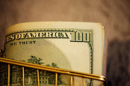 Financial concept, bank notes in the shopping cart. shopping cart with dollars banknotes. financial concept. Many dollars in the cartの写真素材