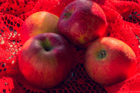 Fresh ripe red apples. Apples on a red background. Healthy food and vitaminsの写真素材