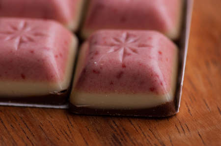 White Chocolate with Mixed Berry bar. Pink white brown chocolate layers. Dessert sweets chocolate