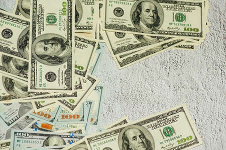Dollars different bills. Dollars background. Background of different us dollar banknotes. Finance concept.の写真素材