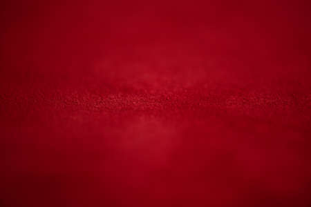 Red matte background of suede fabric, closeup. Velvet texture of seamless leather. Felt material macro. Red suede texture. Fabric, leather, material for designers.の写真素材