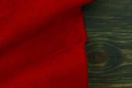 Red matte background of suede fabric, closeup. Velvet texture of seamless leather. Felt material macro. Red suede texture. Fabric, leather, material for designers.の写真素材