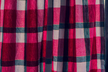 picnic cloth. The checkered tablecloth on a table. Texture of white fabric in a red cell. Background image. Blank checkered fabric textureの写真素材