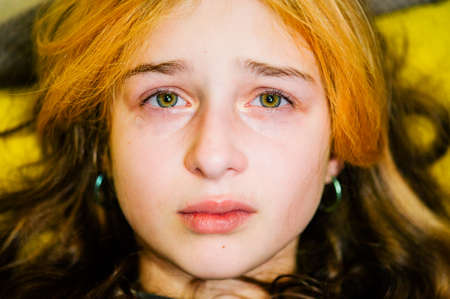 little sad girl after crying. Crying little beautiful girl with sad green eyes and frowning face....