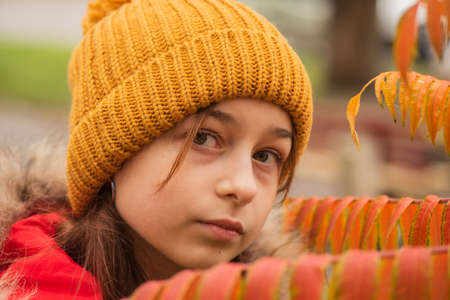 Teenager in a hat on the street. Stylish hipster girl, street fashion. Portrait of beautiful young blonde woman wearing a yellow hat on city streetの写真素材