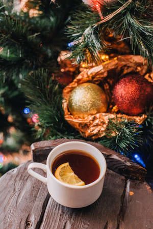 Christmas new year background with lemon. winter still. selective focus. Tea with lemon on the background of a christmas tree.の写真素材