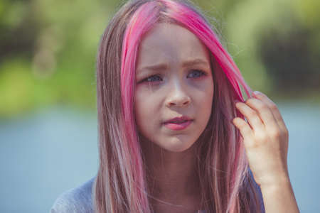 girl portrait. Outdoor portrait of cute little girl in summer day. girl with pink hair. Child 9-10