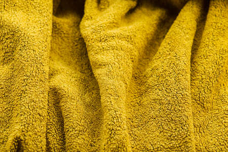 yellow terry cloth towel texture. Yellow terry towel. Yellow background with a textural fabric