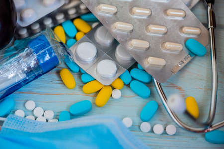 pills, tablets and capsules on a blue background. Medicine and health. Medical maskの写真素材