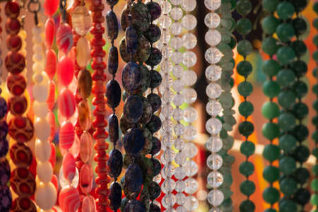 Background from beads. Beads jewelry. Decorations presented on the beach in summerの写真素材