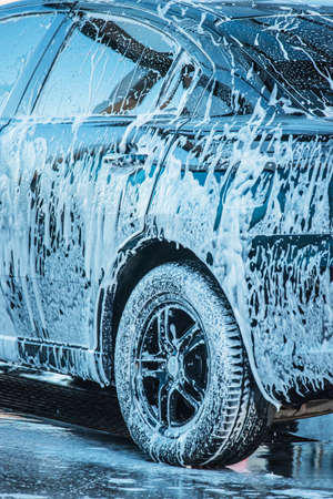 washing the car. Washing a black car at a car wash. Clean carの写真素材