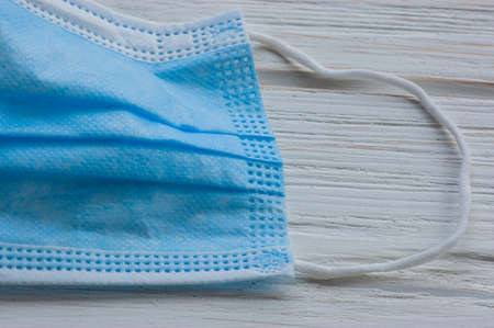 Wood Texture, White Wooden Background, Blue protective mask protection against viruses and bacteriaの写真素材