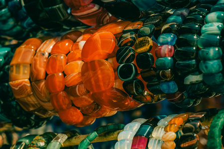 Background from beads. Beads jewelry. Decorations presented on the beach in summer