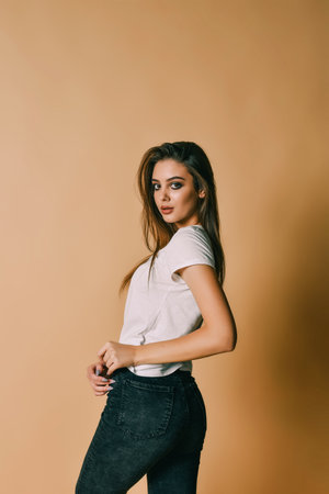 Sexy brunette woman posing. Girl with professional make-up.Pretty woman posing with hands in the...