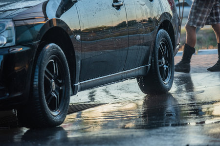 washing the car. Washing a black car at a car wash. Clean carの写真素材