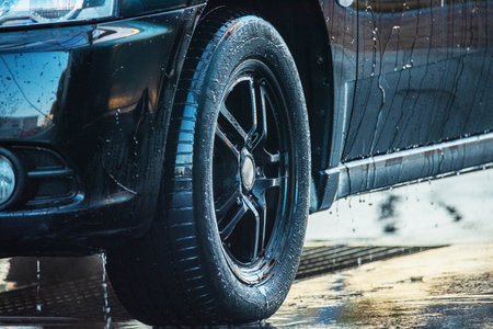 washing the car. Washing a black car at a car wash. Clean carの写真素材