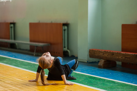 little girl doing gymnastics. little gymnast girl in gym. Girl gymnast in the gym. Sport health.の写真素材