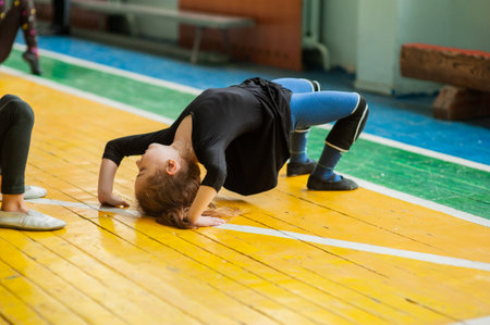little girl doing gymnastics. little gymnast girl in gym. Girl gymnast in the gym. Sport health.の写真素材