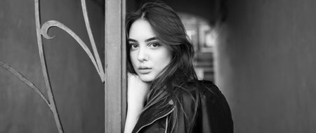 Portrait of a brunette girl 19-20 years old. Beautiful girl. Girl with a serious mood