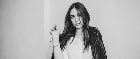 Portrait of a brunette girl 19-20 years old. Beautiful girl. Girl with a serious mood