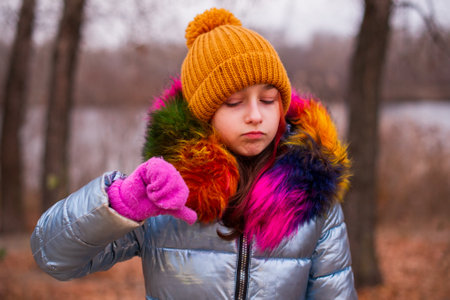 Young beautiful woman wearing winter clothing. Teenage girl in a jacket and hat. School age girlの写真素材