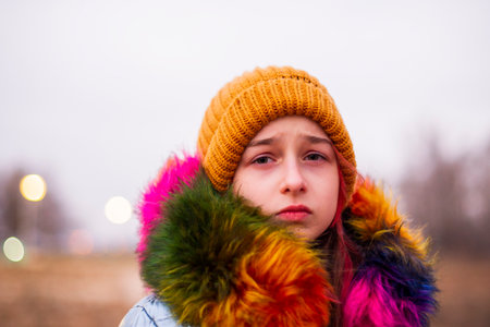 Young beautiful woman wearing winter clothing. Teenage girl in a jacket and hat. School age girlの写真素材