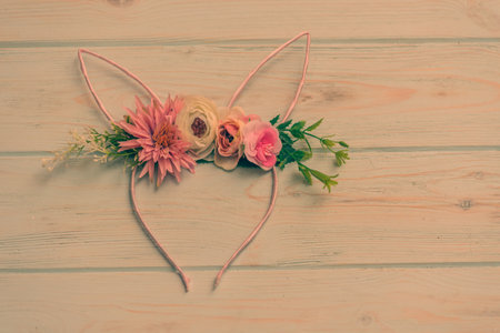happy easter. holiday bunny, spring flower. Pink fluffy rabbit hoop on wooden table.の写真素材