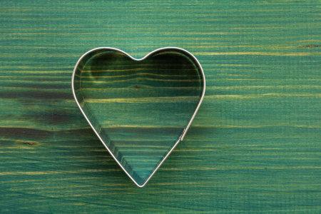 Valentines Day background with heart. Metal heart on wood greenbackgroundの写真素材