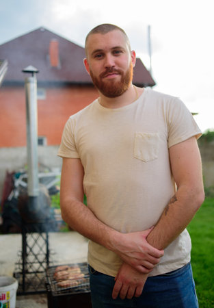 Red-bearded man in summer. Male 28-35 years old. The guy against the sky. The man is smiling.の写真素材