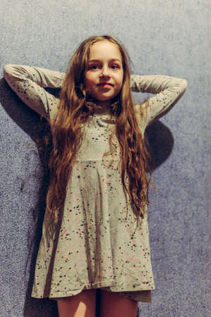 Teenage Girl Portrait. Portrait of a teenage girl at home. Girl with long hair against the wall