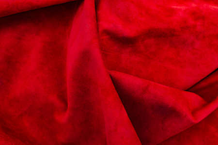 Velvet texture of seamless leather. Felt material macro. Red suede texture. Fabric, leather