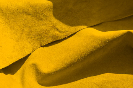 Velvet Yellow texture of seamless leather. Felt material macro. Yellow suede texture. leather