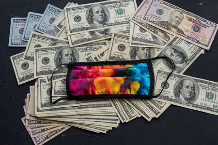 Dollars closeup photo of American Dollar banknotes. Macro shot. virus protection mask.の写真素材