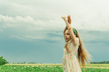 Beautiful young woman in white dress relaxing in apple tree gardenの写真素材