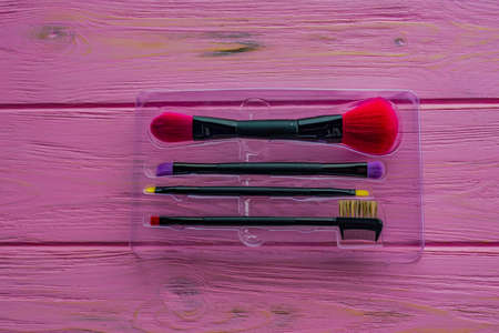 close-up pink professional cosmetic brush. Makeup brushes on a pink background. Instruments for makeの写真素材