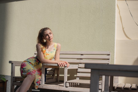 girl in dress walks through the old town in the summer. Beautiful blonde woman summer photo.の写真素材