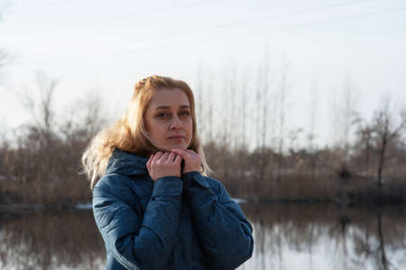 Winter woman walking out on forest walk in cold outdoor nature river outside. outdoors