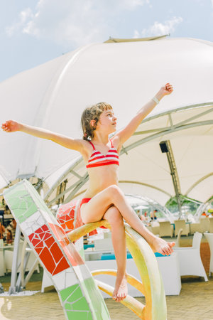 little girl is resting in the summer in the aqua park. Child active summer vacation in summer. girlの写真素材