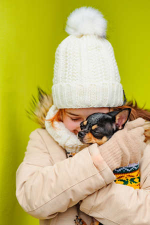 Pretty girl with chihuahua. Teenage girl and chihuahua on the street. Girl, dog.の写真素材