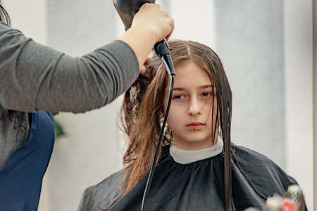 Happy Girl Getting her Hair Cut. A series of photos of a girl getting her hair cut. haircut, girl,の写真素材