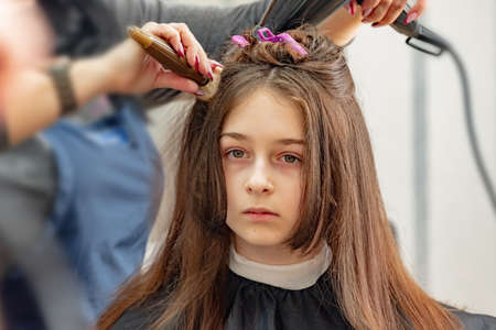 Happy Girl Getting her Hair Cut. A series of photos of a girl getting her hair cut. haircut, girl,の写真素材