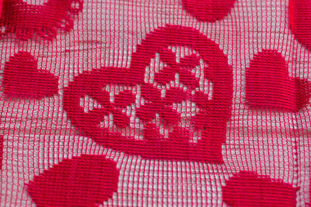 A luxurious red mesh fabric, useful for backgrounds. Red fabric mesh in hearts.